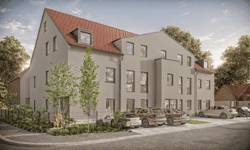 Modernisiertes Mehrfamilienhaus mit rotem Ziegeldach und mehreren Wohnungen